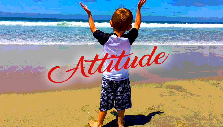 Young boy raising his arm in the air when seeing the ocean for the first time.